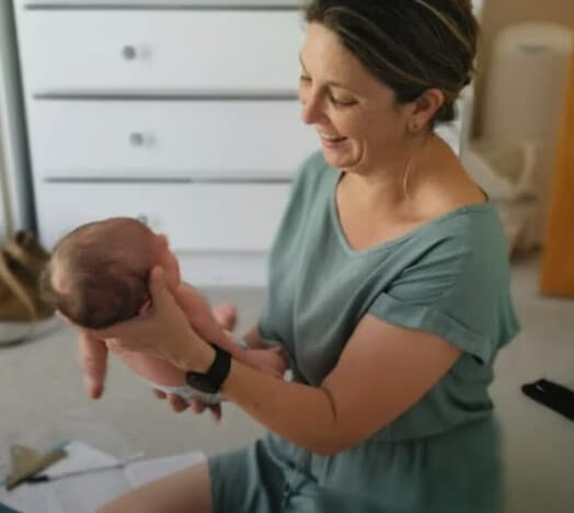 Megan gently holding a newborn