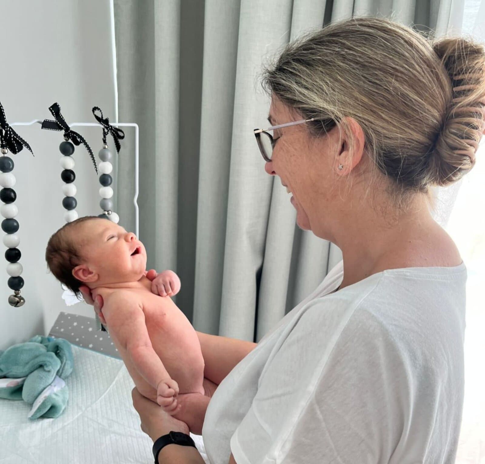 Megan holding a happy newborn